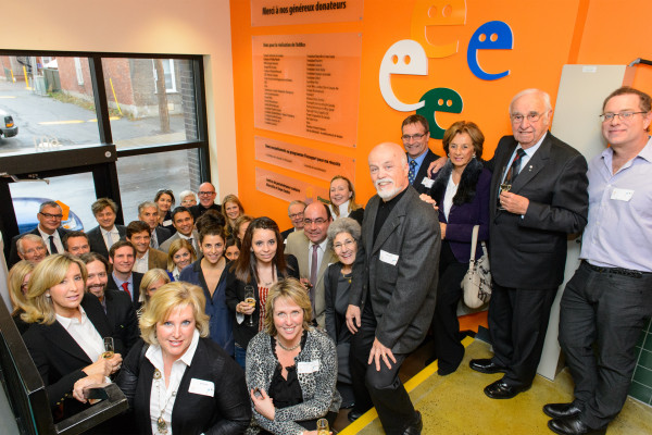 Launch attendees in front of the donors' wall 